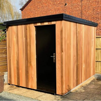 Black security steel door in cladded shed