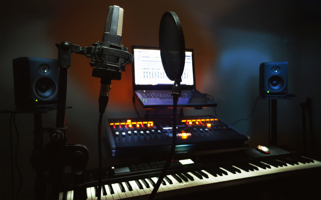 recording studio showing microphone, laptop and keyboard