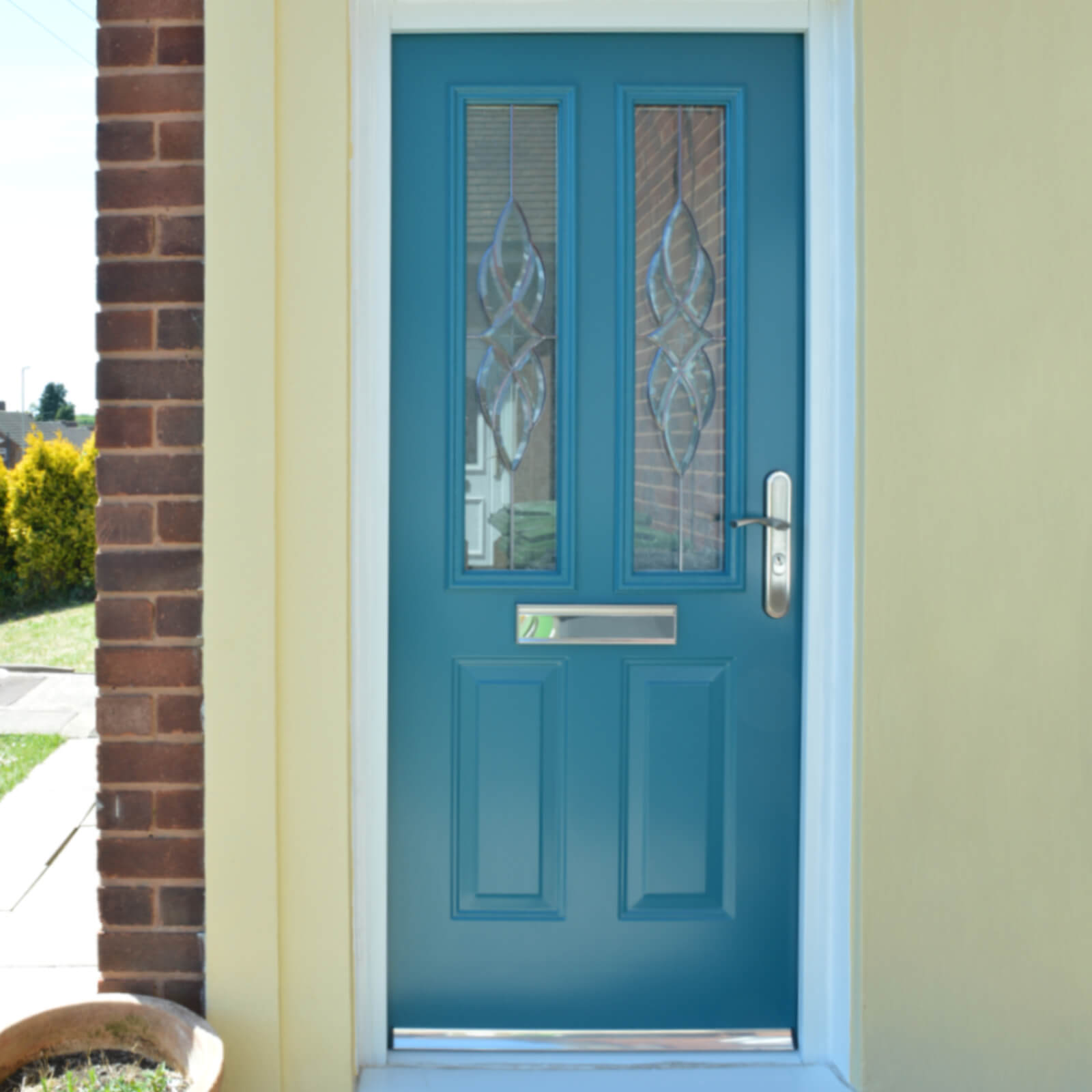 Turquoise traditional front door with patterned glass