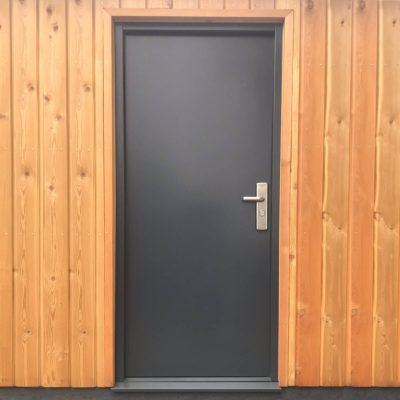 Budget grey steel door in wooden cladded building