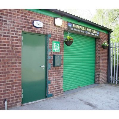 Green steel door installed on a building