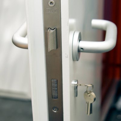 Close up of door lock and handle on a single steel door