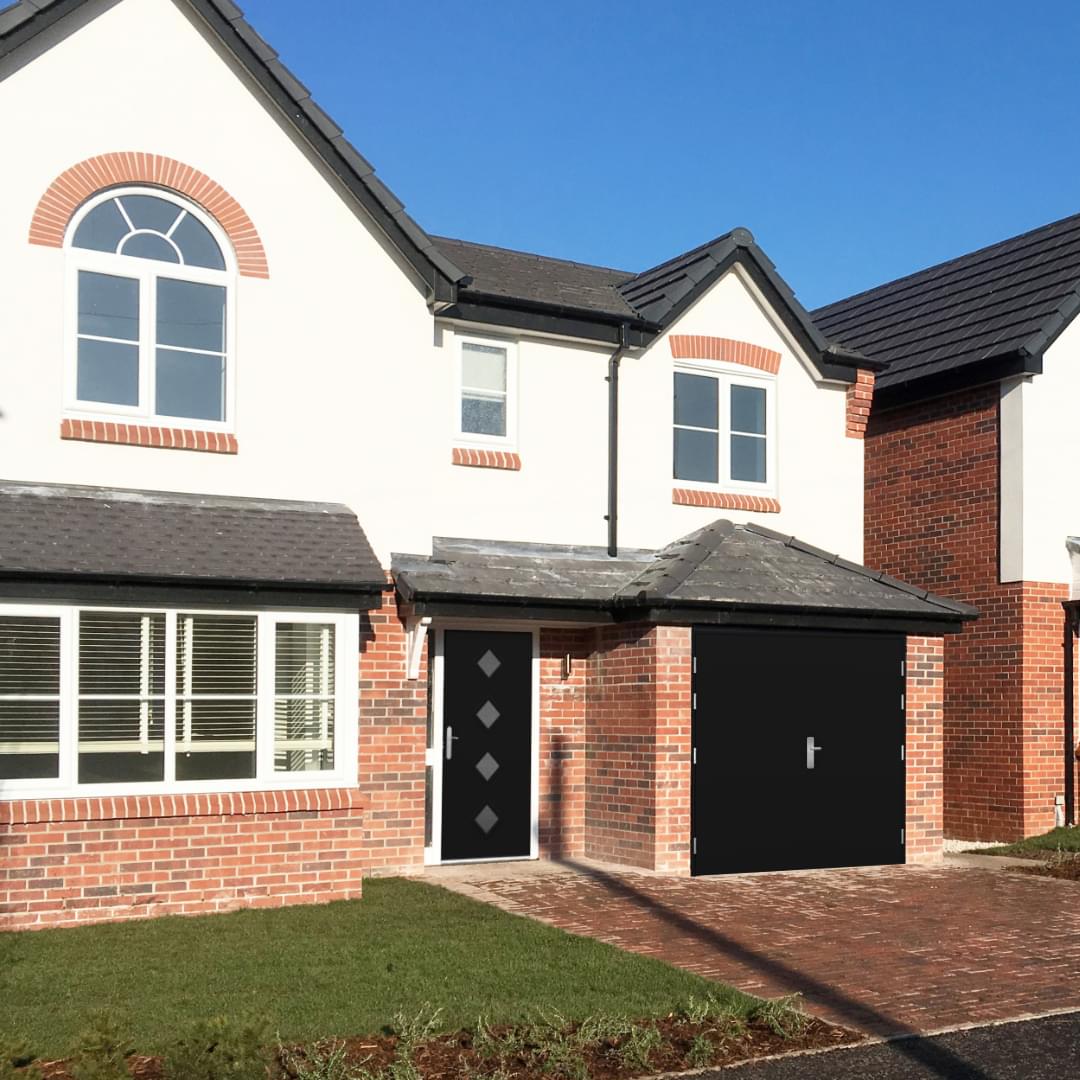 side hinged garage door and front door on a new build house