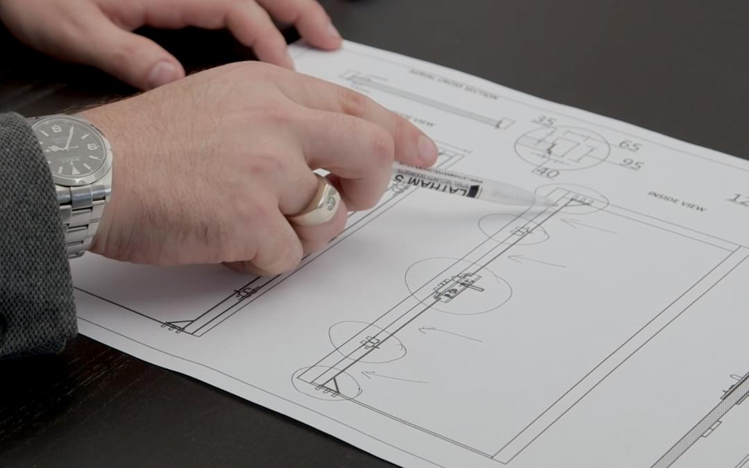 a hand using a pen to point to a product development diagram