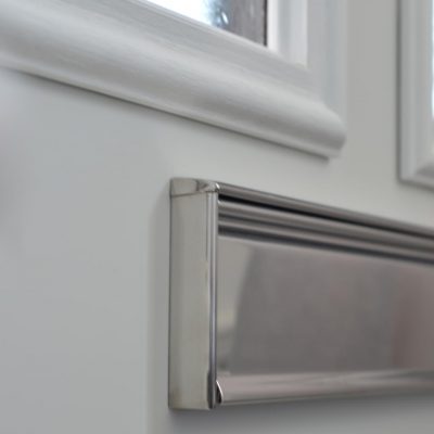 close up of a letterplate on a white door
