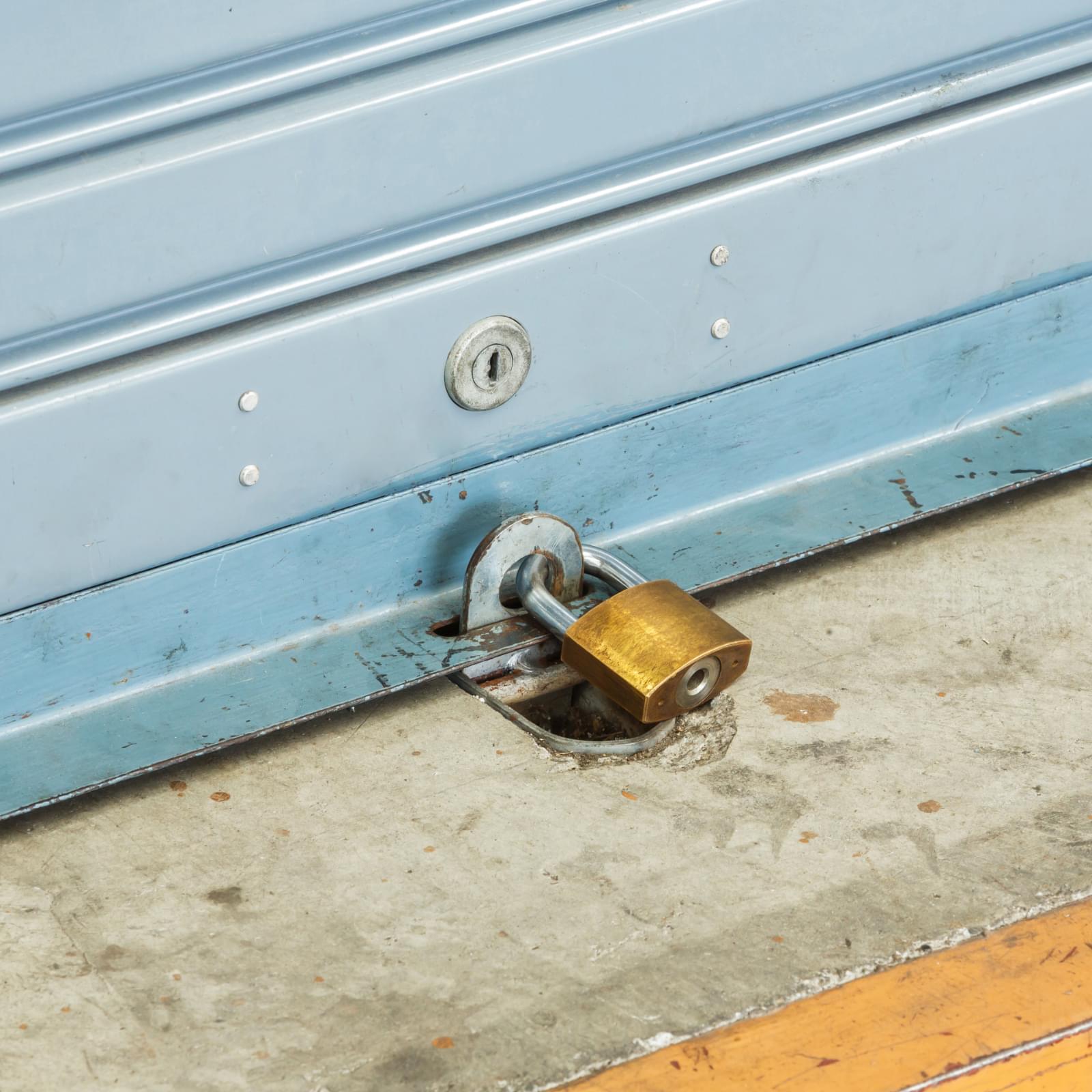 Ground lock on a garage door