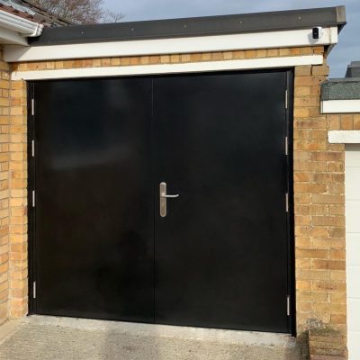black high security side hinged garage door installed