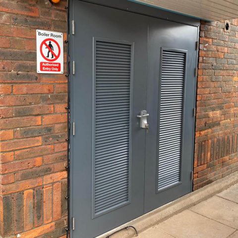 Louvred fire exit door with outer access device fitted