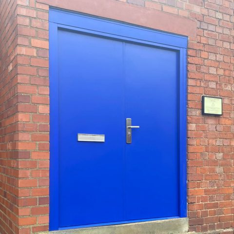 Security double steel door in blue with expanding side panels and over panel