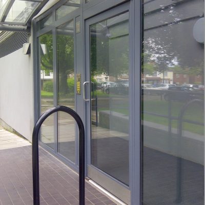 Grey glazed commercial entrance door