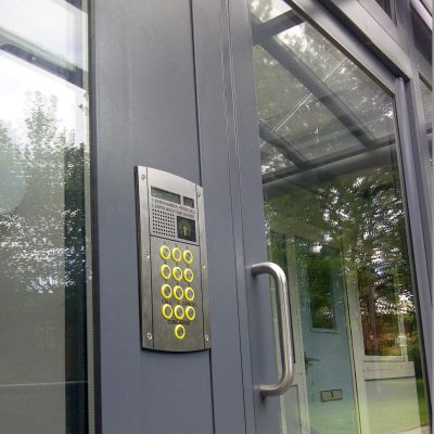 Grey glazed commercial entrance door close up