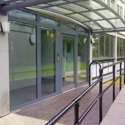 Grey glazed commercial entrance door wide view