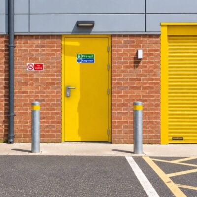 A Latham's yellow security fire exit door with an OAD