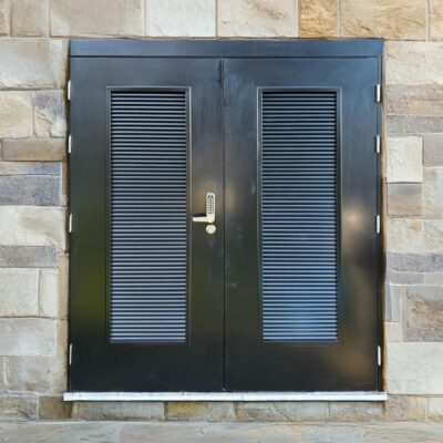 Black louvred double door with codelock