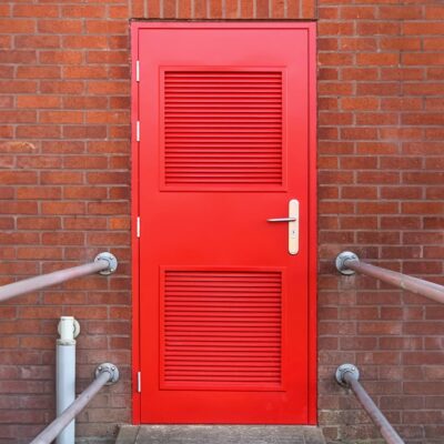 Traffic red PAS 24 louvred steel door
